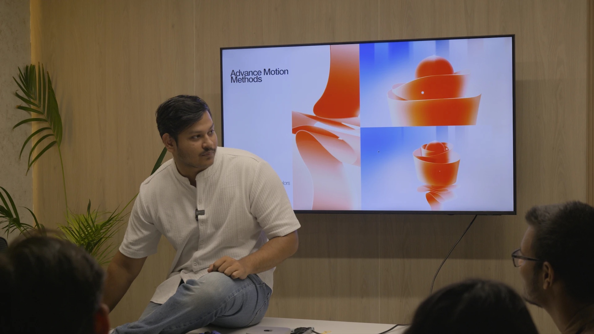 Vivek sitting on a desk, teaching a room of editors, with a slide titled Advance Motion Methods behind him